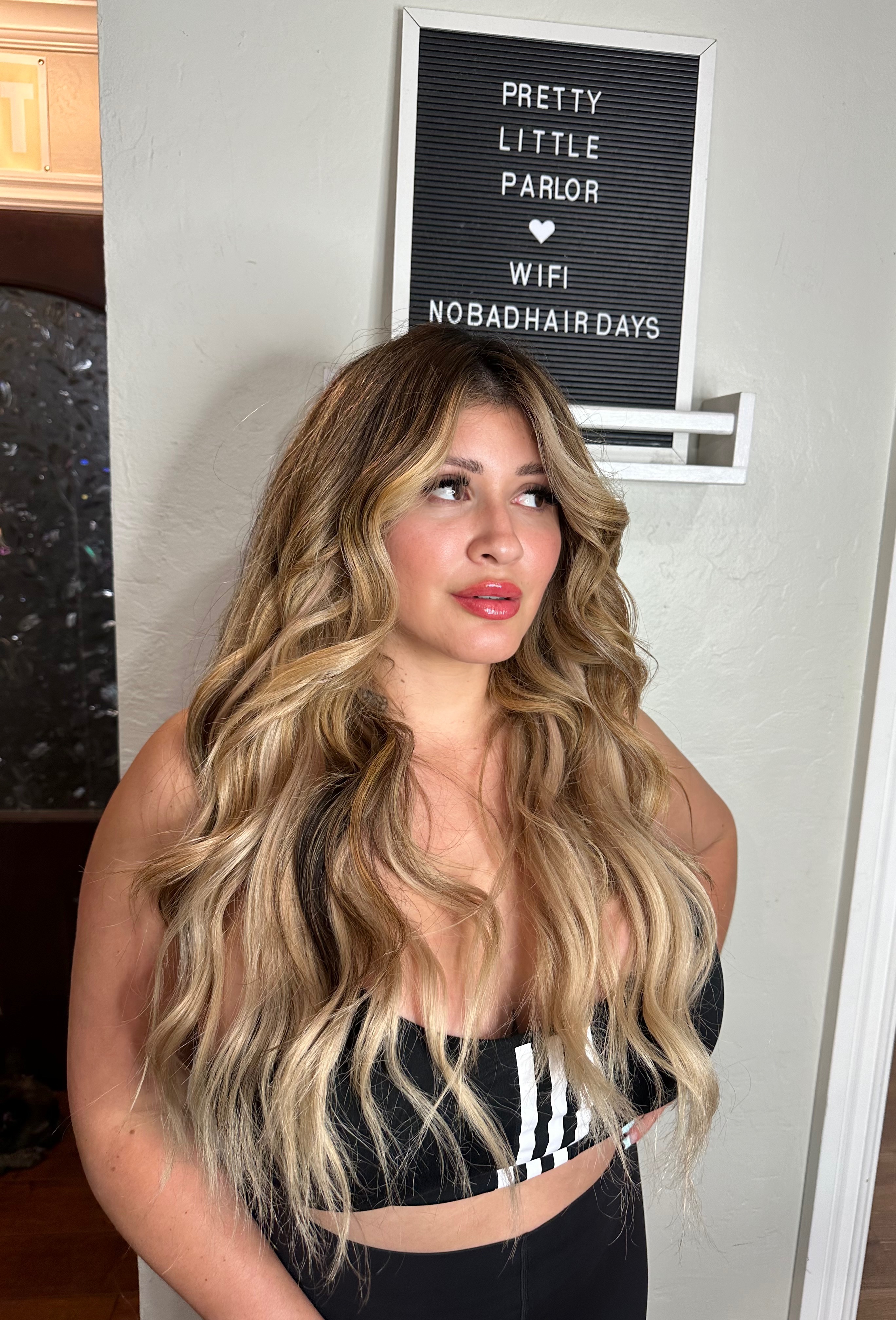Client sandy blonde balayage with long waves